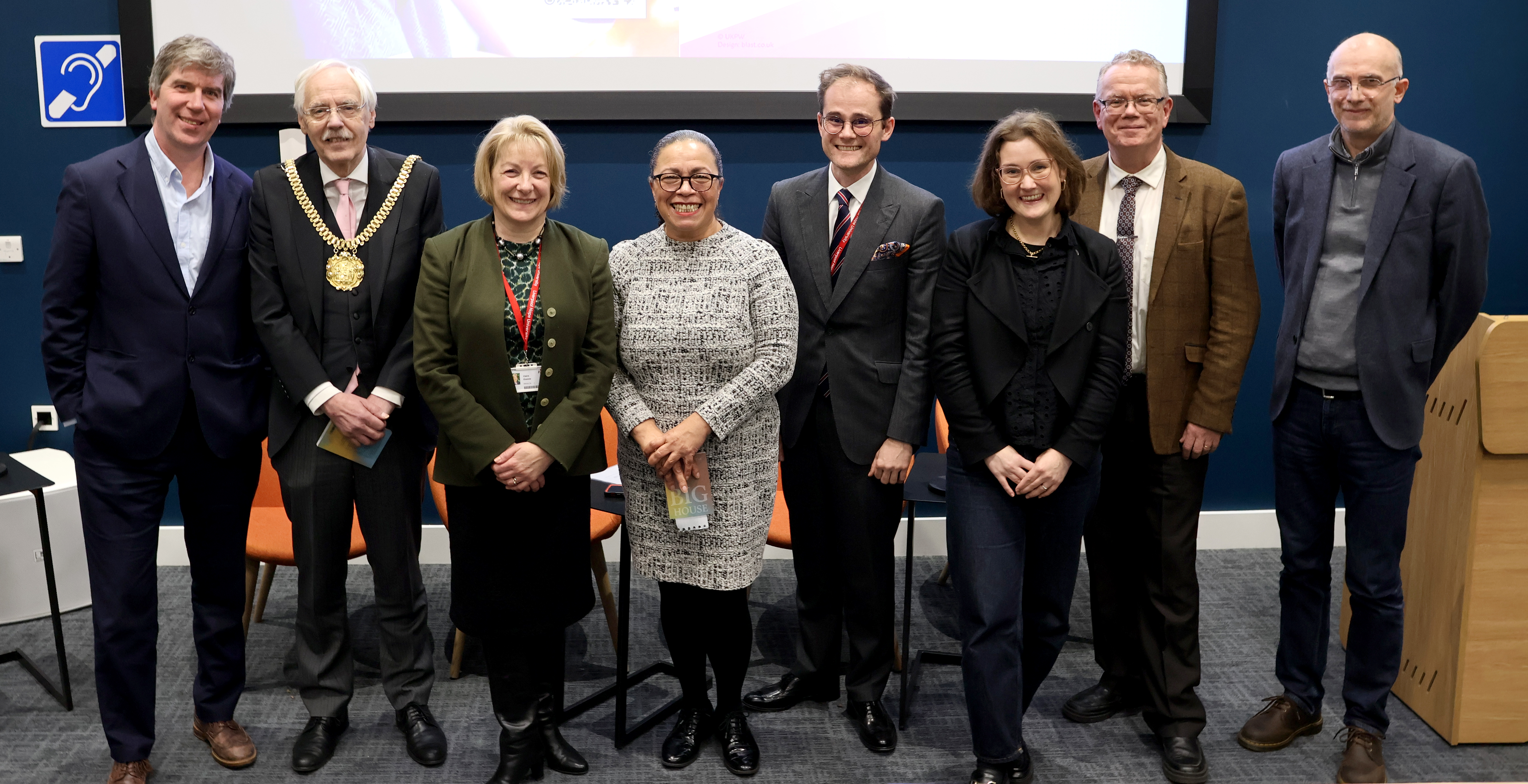Line of senior leaders smiling for photo