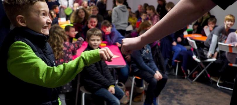 Young person fist-bumping adult