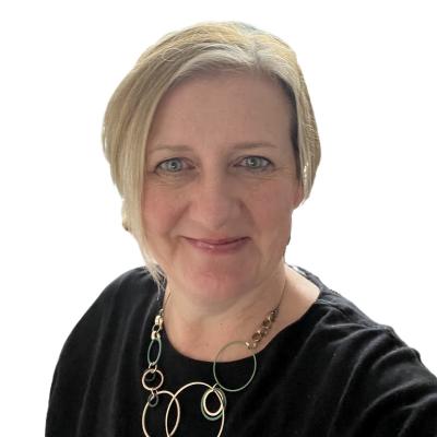 A photograph of Lesley, a smiling white woman with short blond hair