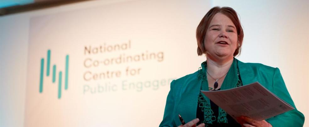 Sophie Duncan presenting at an Engage Conference with NCCPE logo in the background