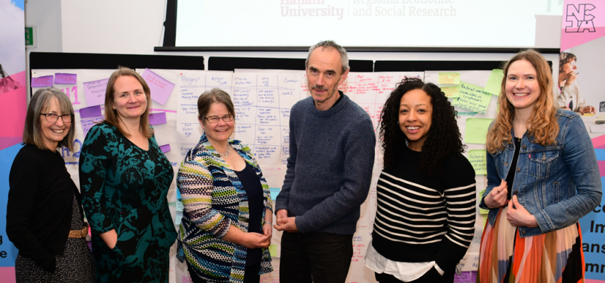 Ann, Zoe, Sophie, Paul, Gemma and Asphodel standing together and smiling at the NCIA action learning event